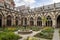 photo of Pandhof van de Dom garden containing herbs and decorative plants, a stone fountain in Utrecht, Netherlands.