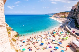 photo of an aerial view of Parghelia in Italy. Overview of seabed seen from above, transparent water and beach with umbrellas.