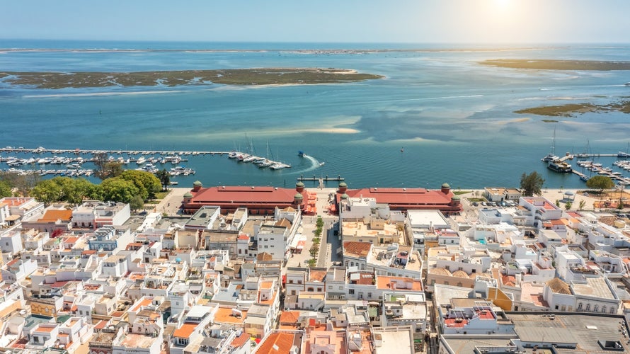 Photo of Aerial view of Portuguese fishing tourist town of Olhao with a view the Ria Formosa Sea port for yachts on a sunny day.