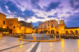 Photo of panoramic view of the ancient town of Matera (Sassi di Matera), European Capital of Culture 2019, in beautiful golden morning light with blue sky and clouds, Basilicata, southern Italy.