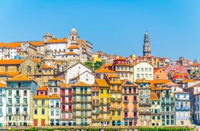 Porto, Portugal old town ribeira aerial promenade view with colorful houses, Douro river and boats.