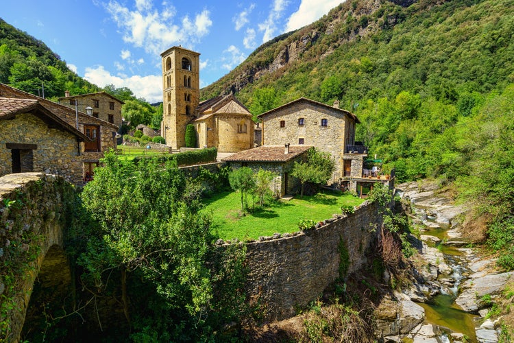 Photo of spectacular mountain village with old houses made of stone and Romanesque church with bell tower, Beget, Girona, Catalonia.