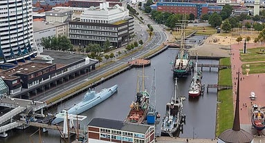 Photo of aerial view of the city of Bremerhaven with the harbor and traditional sailing-ships, Germany.