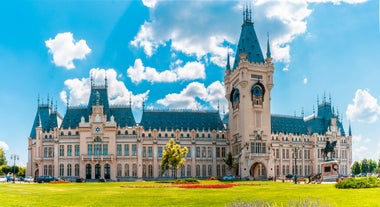 Photo of Water fountain in central square in Iasi town, Cultural Palace in background, Moldavia, Romania.