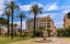 photo of Triton Fountain at Albert I Garden its ancient Greek statue and historical monument with Mediterranean house facades in Nice, France.