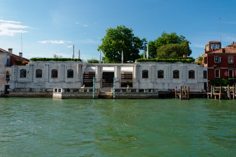 photo of the Grand Canal and the Peggy Guggenheim Collection. Clear blue skies and wonderful water in the canal. Perfect water trip for a tourist venice italy.
