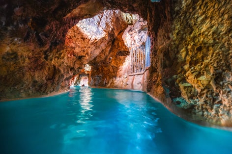 photo of view of Miskolc, Hungary - 3. june. 2022: Tourists enjoy at the cave with thermal water - natural SPA in Hungary at Miskolc Hungary. Rock tube with thermal water