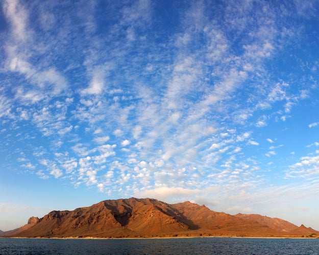 Photo of panoramic view of Santa Luzia volcanic island with beautiful evening sky.