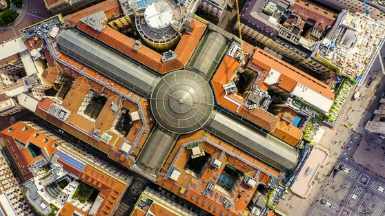 photo of milan, Italy. Gallery of victor emanuel II 1865-1877 year of construction. Roofs of the city aerial view, head over shot.