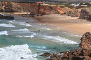 Photo of aerial view of beautiful lighthouse located on high cliffs of Saint Vincent cape in Sagres, Algarve, Portugal.