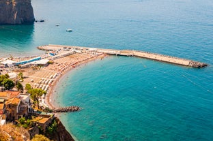 photo of aerial panorama of high cliffs, Tyrrhenian Sea Bay with pure azure water, floating boats and ships, pebble beaches, rocky surroundings of Meta in Sant'Agnello and Sorrento cities near Naples region in Italy.