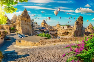 Hot air balloons flying over Uchisar Castle. Cappadocia. Nevsehir Province. Turkey.