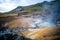 photo of empty geothermal krysuvik area on reykjanes peninsula in Iceland on early summer morning. Visible sulphur rising from the ground.