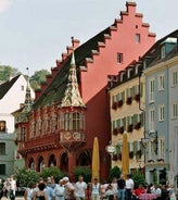 Photo of aerial view of the historic city center of Freiburg im Breisgau from famous old Freiburger Minster in beautiful evening light at sunset, Germany.