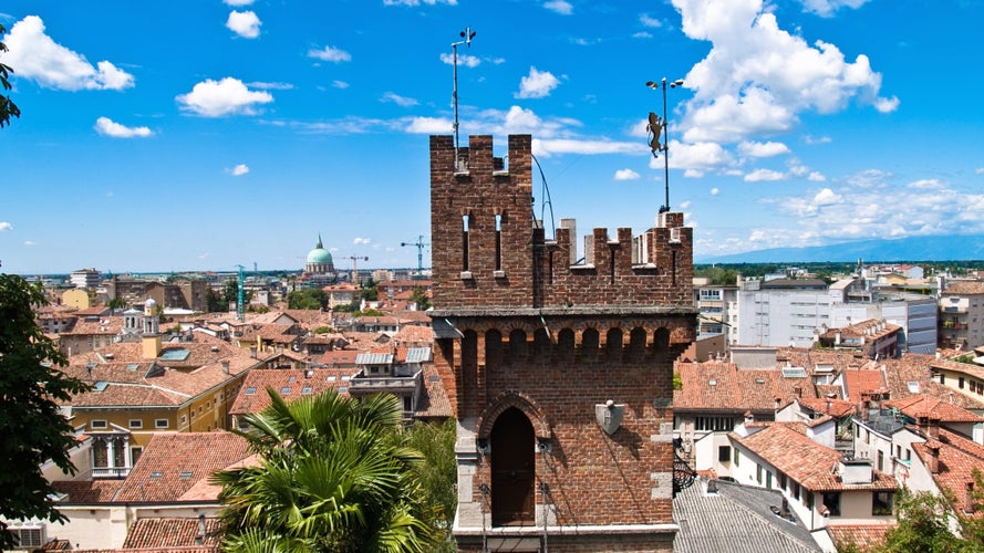 Aerial panoramic view of historic city of Udine, Friuli Venezia Giulia, Italy, Europe. Viewing platform form castle of Udine. Dark clouds on overcast day. Classical Italian architecture red roofs