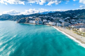 photo of Almuñécar, Spain - A scenic view of a coastal city with white buildings and a blue ocean in the background.