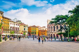 Photo of aerial view of Verona historical city centre, Ponte Pietra bridge across Adige river, Verona Cathedral, Duomo di Verona, red tiled roofs, Veneto Region, Italy.