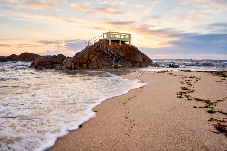 View point or gazebo over the rocks on a beach in Vila do Conde, Portugal, at sunset.