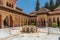 Photo of Patio de los Leones inside of the Nasrid palace of Alhambra fortress in Granada, Spain.