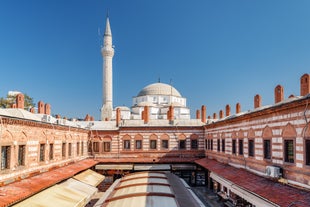 Touristic sightseeing ships in Golden Horn bay of Istanbul and mosque with Sultanahmet district against blue sky and clouds. Istanbul, Turkey during sunny summer day.