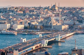 Touristic sightseeing ships in Golden Horn bay of Istanbul and mosque with Sultanahmet district against blue sky and clouds. Istanbul, Turkey during sunny summer day.