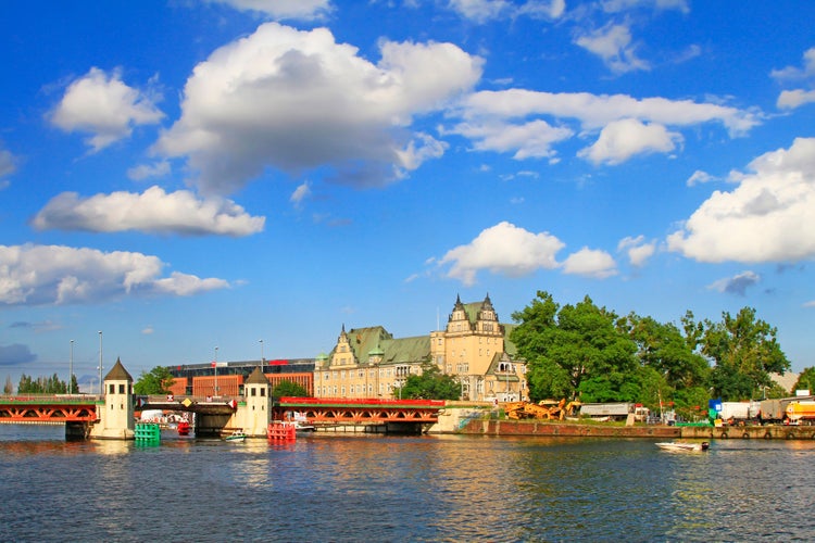 Photo of landscape of Szczecin with the red metallic bridge with towers across the Oder river, Poland.