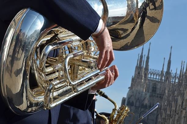 Musician playing a flugelhorn in front of the iconic Milan Cathedral.jpg