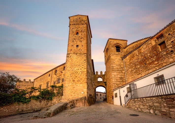 photo of arch between towers on Ballesteros street in Trujillo, Cáceres, Extremadura, Spain, with early morning light.