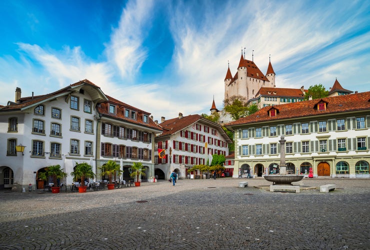 Photo of Amazing view of City Hall square and castle of Thun, Switzerland under picturesque sky. Thun city is a popular travel destination and tourist attraction in Switzerland.