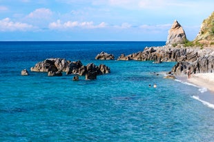 photo of an aerial view of Parghelia in Italy. Overview of seabed seen from above, transparent water and beach with umbrellas.