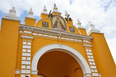 Photo of macarena door arch in seville , spain .