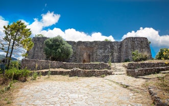 Photo of temple of Apollo with Acrocorinth in the background. Ancient Corinth, Greece.