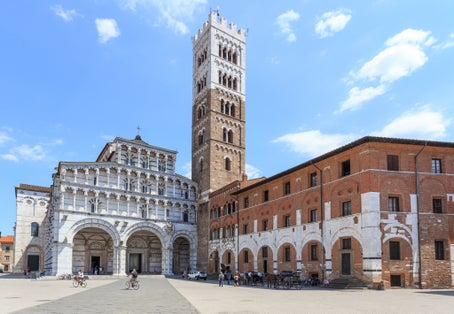 photo of view ofRomanesque Facade and bell tower of St. Martin Cathedral in Lucca, Tuscany. It contains most precious relic in Lucca, Holy Face of Lucca (Italian: Volto Santo di Lucca),Bologna italy.