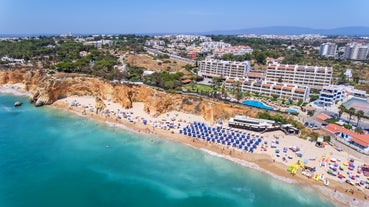 Photo of aerial view of touristic Portimao with wide sandy Rocha beach, Algarve, Portugal.