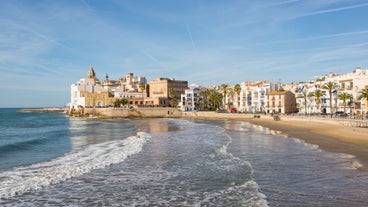 Photo of Sand beach and historical Old Town in mediterranean resort Sitges near Barcelona, Costa Dorada, Catalonia, Spain.