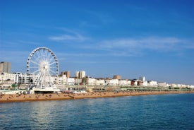 Photo of panoramic view along Brighton Beachfront with the promenade and Ferris Wheel backed by highrise buildings, UK.