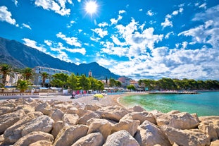 Photo of panorama and landscape of Makarska resort and its harbour with boats and blue sea water, Croatia.