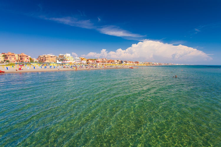 Swimming and relaxing people on the beautiful beach Lido di Ostia ( Lido di Roma), private beach Battistini, Italy.