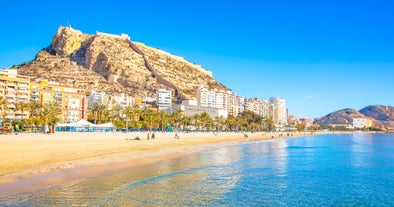 Photo of aerial panoramic view coastline and La Vila Joiosa Villajoyosa touristic resort townscape, sandy beach and Mediterranean seascape, Costa Blanca, Spain.