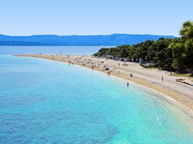 Photo of panorama and landscape of Makarska resort and its harbour with boats and blue sea water, Croatia.