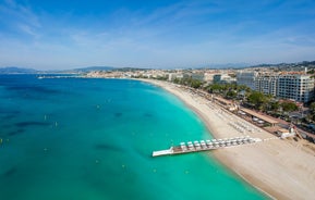 Photo of aerial cityscape view on French riviera with yachts in Cannes city, France.