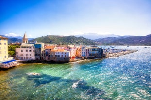 Photo of aerial view from the walls of the citadel of Calvi on the old town with historic buildings and bay with yachts and boats, Corsica, France.