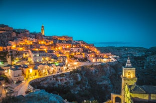 Photo of panoramic view of the ancient town of Matera (Sassi di Matera), European Capital of Culture 2019, in beautiful golden morning light with blue sky and clouds, Basilicata, southern Italy.