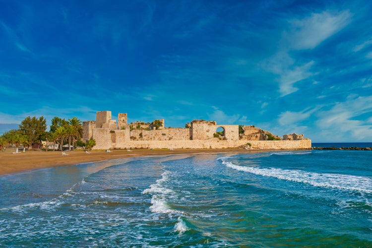 Photo of historical Ancient Kizkalesi, Kiz Kalesi or Maiden's Castle with Korykos Ruins in Mersin Beach from Turkey.