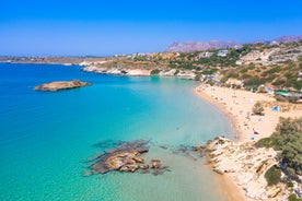 Photo of aerial view of black Perissa beach with beautiful turquoise water, sea waves and straw umbrellas, Greece.