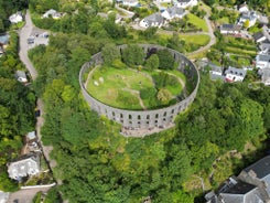 Photo of aerial view of Aberdeen as River Dee flows in a curve to the North Sea showing Duthie Park with bridge and traffic from south.