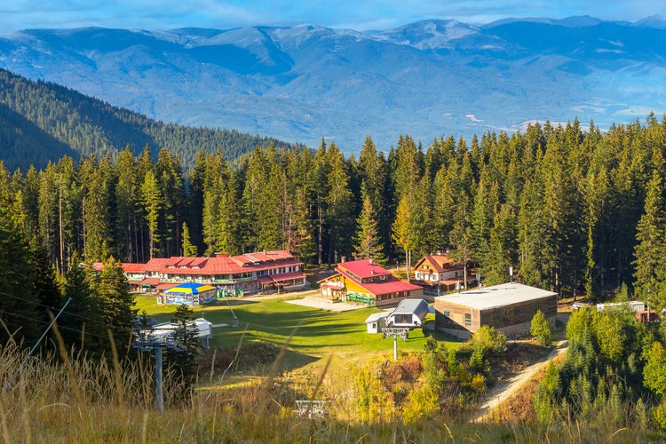 Photo of Bansko, Bulgaria Shiligarnika autumn ski resort view with hotel house, mountains and ski lift.