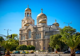 Photo of aerial view of The Cathedral of the Assumption and Varna city at amazing sunset, Bulgaria.