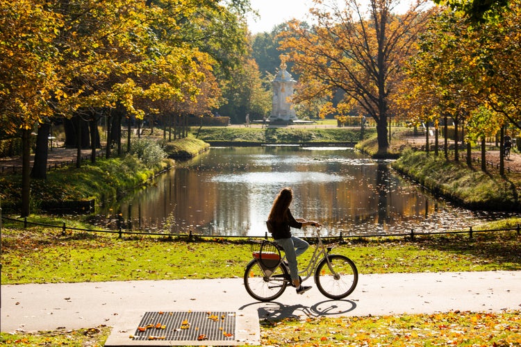 A female cyclist rides a bicycle in the Tiergarten park in Berlin.jpg