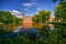 photo of Breda Castle and the surrounding park with reflection in water situated near the Dutch city of Breda in Netherlands.